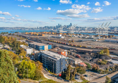 Shot from overhead of multistory building showing its location near West Seattle Bridge and across the water from downtown .