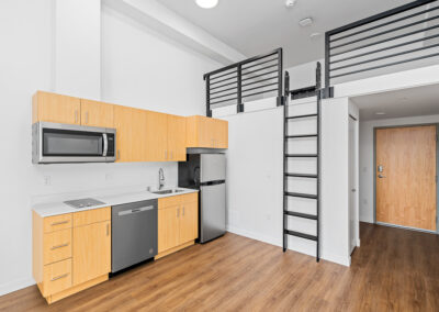 Interior of apartment with nice finishes and appliances and a sleeping loft.