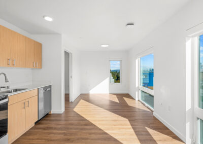 Interior of an open and light filled apartment with nice finishes.