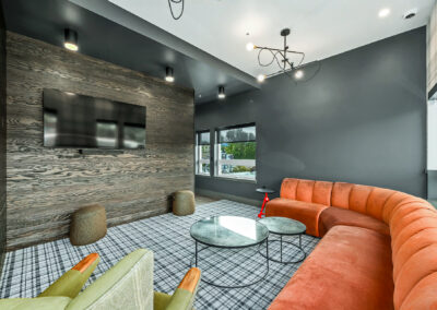 Resident lounge at 900 Rainier featuring seating area with sectional sofa and flat-screen TV.