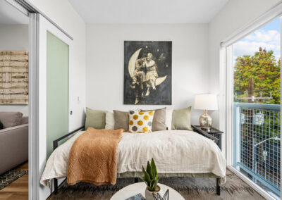 Bedroom at The Keystone, 9201 Delridge, with large windows and natural light.