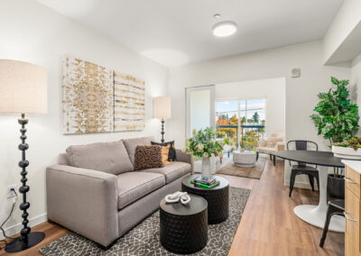 Living room at The Keystone, 9201 Delridge, featuring sofa and bright lighting.