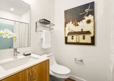 Bathroom at The Keystone, 9201 Delridge, with vanity and wall art.