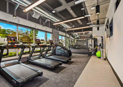 Fitness center at 900 Rainier with treadmills, equipment, and large windows.